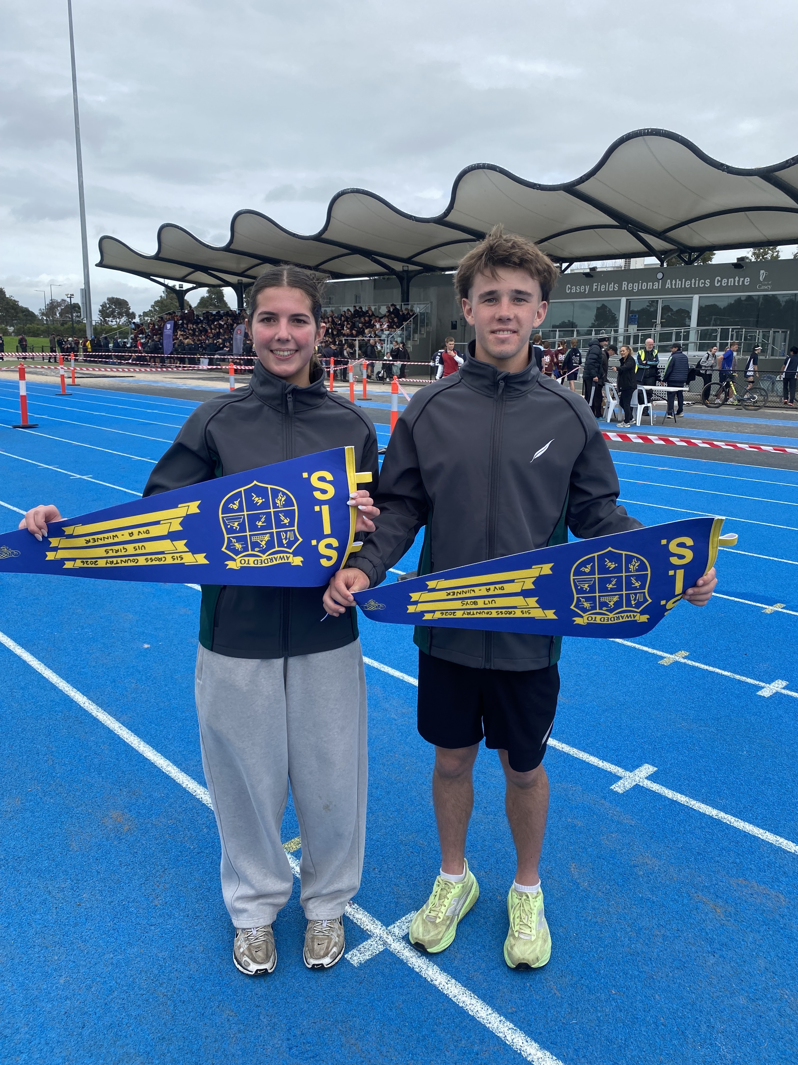 Essie Foley Harvey Bedford team captains0 with the pennants