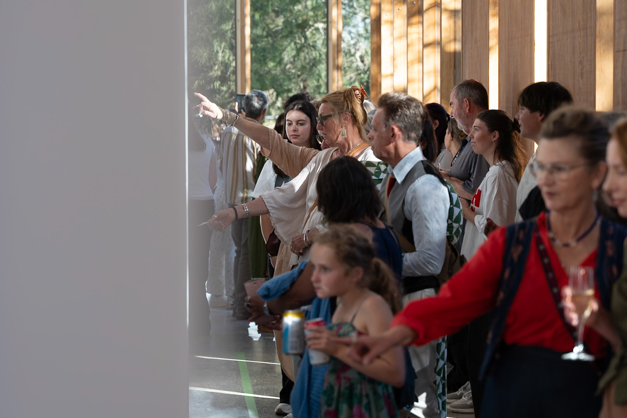 Families walking through the Dame Elisabeth Murdoch Gallery at Woodleigh School for Threads of Belonging Opening Night 2026